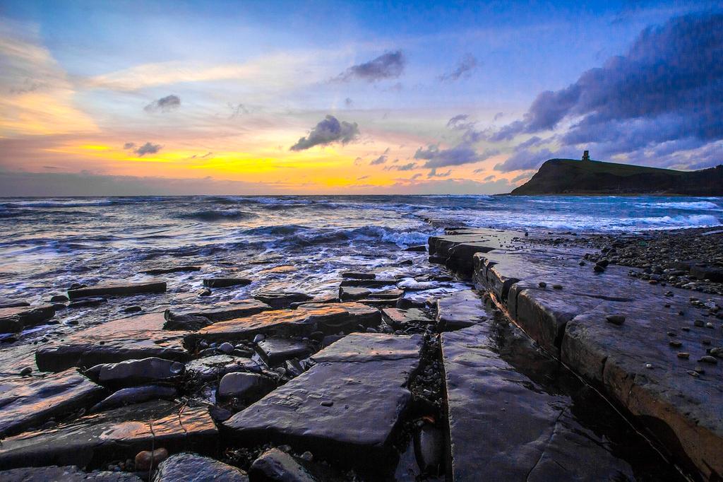 Sunset over beach and palm trees in Bali